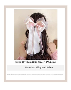 Detailed size view of the 30x19cm pink and white gauze bow hair clip on model