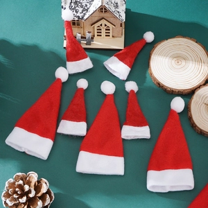 Detailed view of eight red felt mini Christmas hats in two sizes on a green backdrop