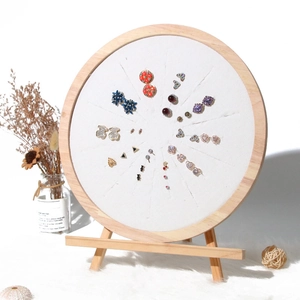 Wooden round earring display stand with white fabric insert and mini easel base