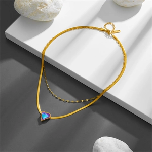 Double-layer stainless steel gold necklace with gradient heart pendant on white pedestal