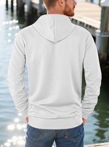 Detail of men's white hoodie showing intricate geometric herringbone fabric texture