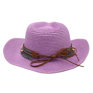 Detail of purple straw cowboy hat with ethnic band, wooden beads and grey tassels