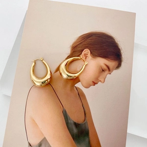 Polished gold teardrop earrings in a large geometric hollow design for women