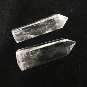 Polished natural clear quartz crystal hexagonal pillars on a black velvet background