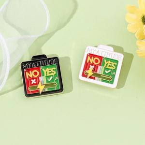 Detail of sliding My Attitude enamel pins in black and white with Yes No options