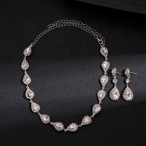 Detailed macro view of pear-cut crystal jewelry set including necklace and earrings