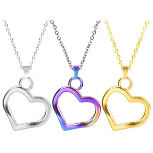 Three minimalist heart-shaped hollow pendants in silver, gold, and rainbow finishes