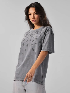 Close-up of vintage washed gray cotton t-shirt featuring rhinestones and H pattern prints