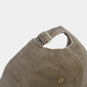 Detail of olive green washed cotton baseball cap with adjustable retro brass buckle