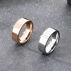 8mm rose gold and silver polished tungsten steel rings on a dark textured surface