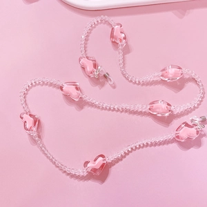 Close-up of pink heart beaded glasses chain with transparent crystals and metal hooks