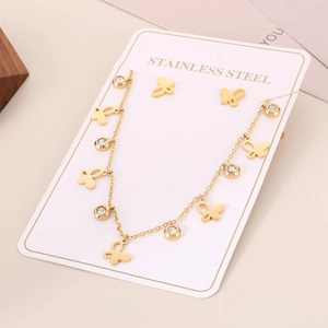 Close-up of golden stainless steel necklace set featuring hollow butterfly and zircon accents