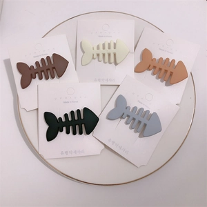Detailed set of 5 matte fishbone hair clips in muted candy colors on display