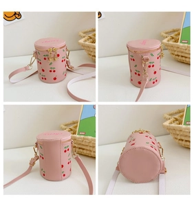 Detail view of pink cherry print bucket bag showing various angles and golden hardware