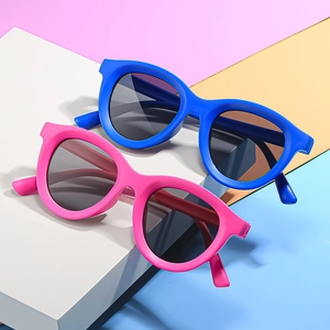 Vibrant blue and pink children's sunglasses on white blocks with colorful background