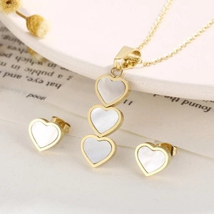 Elegant gold heart jewelry set with white mother of pearl necklace and stud earrings