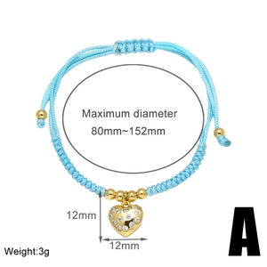 Detail view of woven blue rope bracelet with gold heart pendant and size dimensions