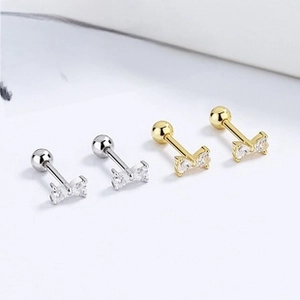Detailed macro view of 925 silver ribbon bow stud earrings with sparkling cubic zirconia