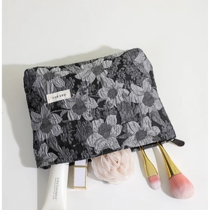 Trousse de maquillage jacquard florale noire et grise avec texture en relief 3D et zip