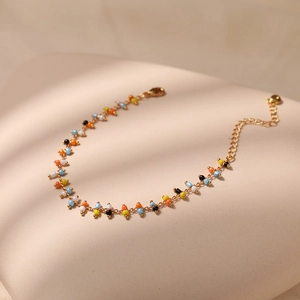 Detail of colorful beads and gold plated chain of the bohemian style bracelet