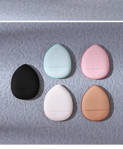 Macro detail of five colorful teardrop mini finger puffs in various shades on grey background