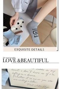 Close-up of cotton socks with polka dots and smile pattern on a minimalist desk