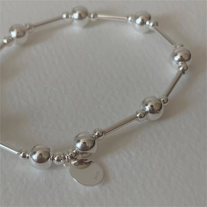 S925 sterling silver beaded bracelet with polished tubes and round logo tag
