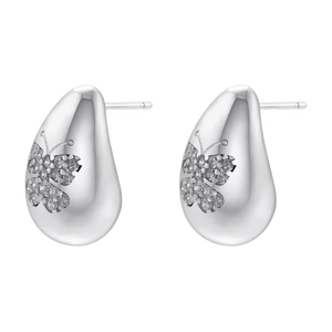 Detailed macro view of silver teardrop stud earrings with cubic zirconia butterfly accent