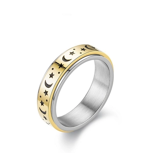 Macro view of gold spinner ring with star and moon engraving on rotating band