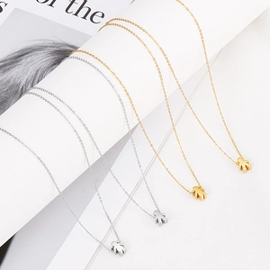 Polished stainless steel necklaces featuring boy and girl pendants in gold and silver