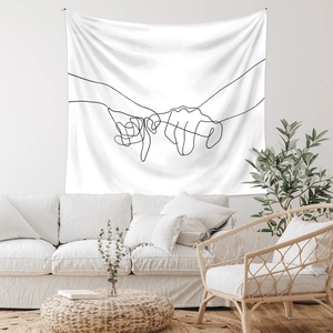 Detail of white tapestry with minimalist black line art of two hands linking pinky fingers