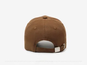 Detail of adjustable metal buckle with LA&DH engraving on brown cotton baseball cap