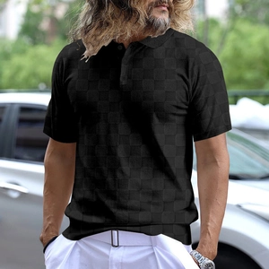 Close-up of black polo shirt featuring textured checkerboard pattern and polo collar
