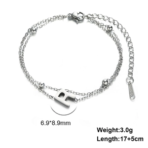 Detailed view of stainless steel double layer bracelet with letter R pendant and beads