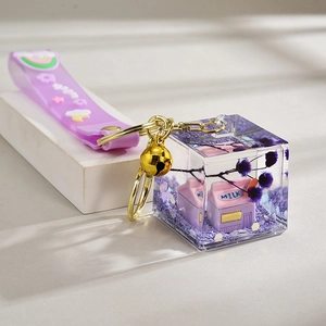 Cute purple liquid oil keychain featuring milk boxes and dried flowers in a cube charm