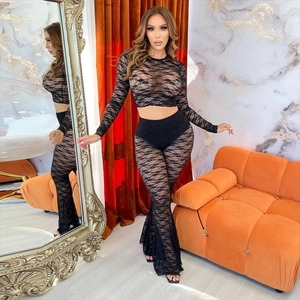 Women's black lace two-piece set featuring long sleeve crop top and flared trousers