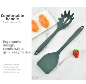 Detail of dark green silicone turner and pasta server with ergonomic hanging handle