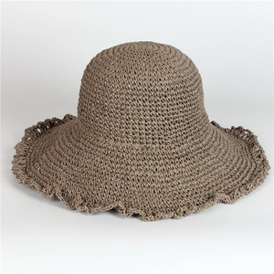 Detail of a brown woven straw hat showing wavy brim texture and natural fiber pattern