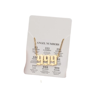 Golden stainless steel angel number 999 necklace with release meaning on display card