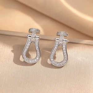 Micro-pave horseshoe buckle earrings in polished titanium steel with cubic zirconia studs