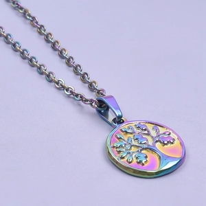 Detailed macro view of rainbow plated stainless steel tree of life pendant on a chain