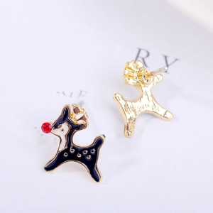 Macro view of gold-tone reindeer stud earrings with black enamel and red rhinestone details