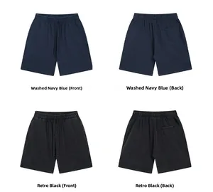 Detail view of washed vintage cotton shorts in navy blue and retro black showing textures