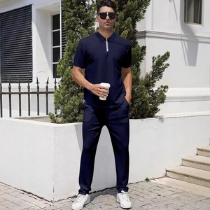 Men's navy half-zip polo shirt and trousers two-piece set shown on model in outdoor light