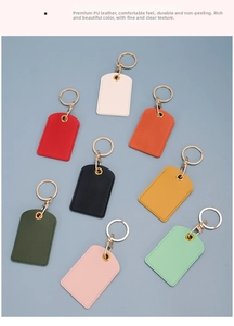 Flat lay of nine colorful PU leather keychains with golden hardware on a blue background