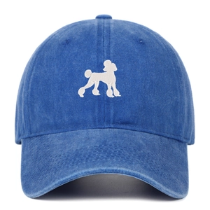 Close-up of white poodle embroidery on washed blue cotton vintage baseball cap