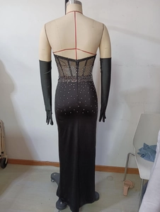 Detail of backless black evening dress with sheer mesh, rhinestones and opera gloves