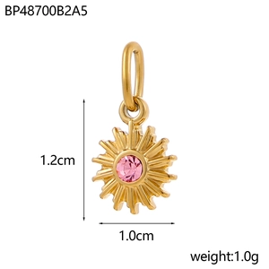 Detail view of a 1.2cm gold sun pendant with pink gemstone and measurement annotations