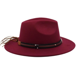 Detail view of burgundy fedora hat featuring black braided band and leather tassels