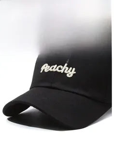 Close-up of white Peachy letter embroidery on a premium black cotton baseball cap